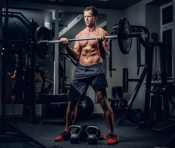 istock A man doing biceps workouts with dumbbells in a gym club. 914650736