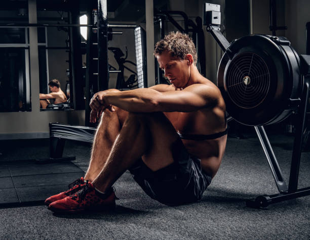 istock Tired sporty male after workouts on power exercise machine. 914650774