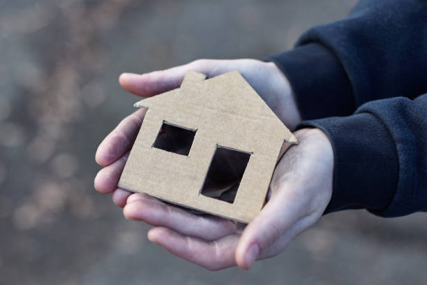 istock young homeless boy holding a cardboard house 914650884