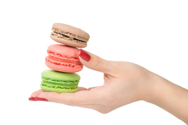 istock Woman hand holding macaroons isolated with clipping path 914651678