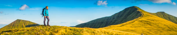 istock Young woman hiker exploring mountain peak panorama Brecon Beacons Wales 914651812