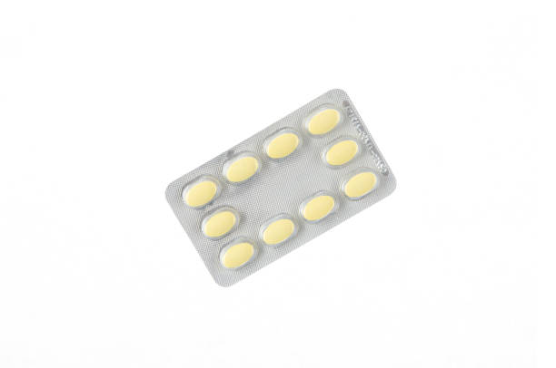 istock a plate of yellow pills on a white isolated background 914658808