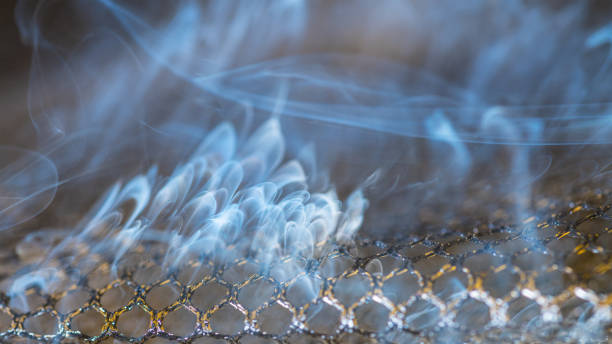 close-up of dangerous smoke fumes and scorched netting. idea of fire, industry, environment - toxic substance smoke abstract green imagens e fotografias de stock