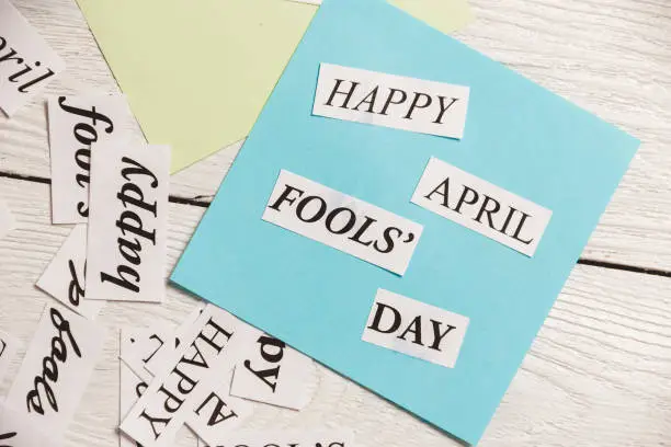 Photo of April Fools Day printed phrase on wooden background