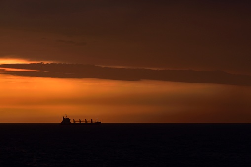 Sailing into Durban, South Africa, with a dramatic sunrise, well not so dramatic for being at sea, but anyway there you are with a ship sailing under the sun on the horizon