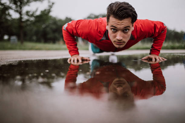 istock Young athletic man exercising after rainy day 914675486