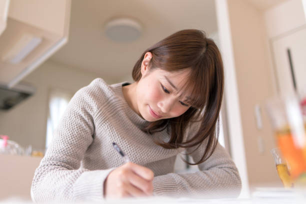 istock Young wife working in dining room 914680360