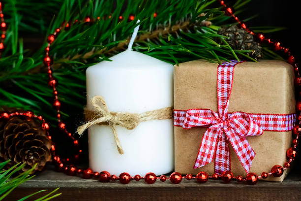 istock Candle on the table near the Christmas tree. Christmas present 914682770