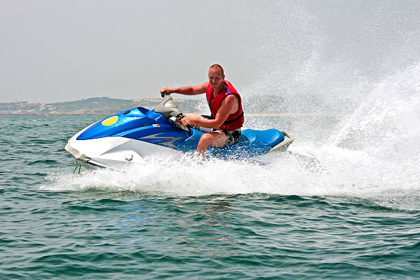 istock man on a high speed jet ski with water spray 91468489