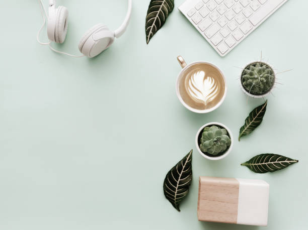 Blogger Pastel Background With Coffee Cup, Headphones and botanical elements. Flat Lay