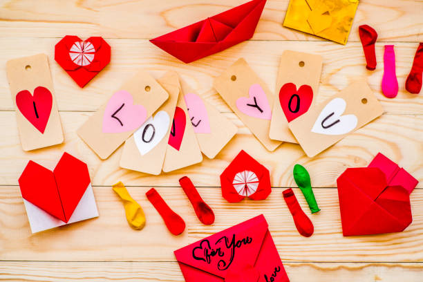 istock valentine's day holiday. various decorations on rusctic background. paper boat, balloons, envelopes and hearts 914687684