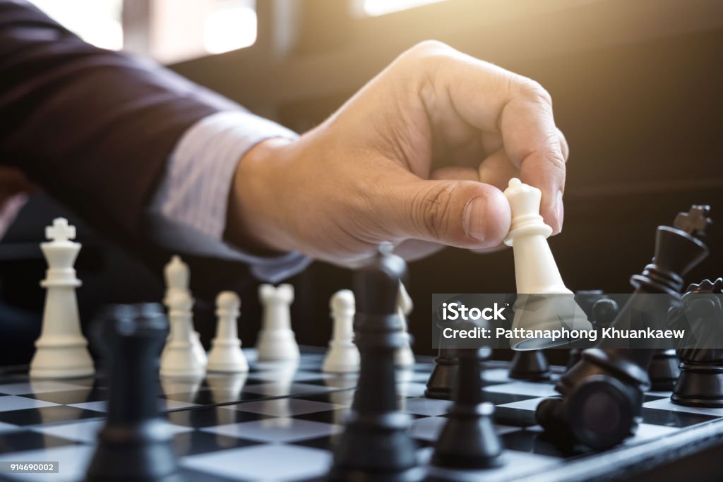 Close up of hands confident businessman colleagues playing chess game to development analysis new strategy plan, leader and teamwork concept for success. Chess Stock Photo