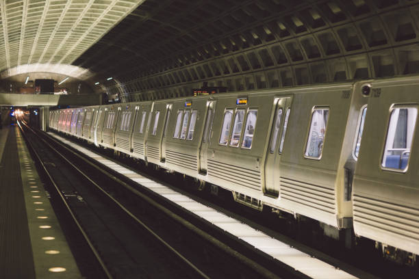istock Train At Illuminated Railroad Station At Night 914690384