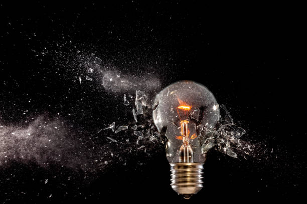 istock Close-Up Of Broken Light Bulb Against Black Background 914691852