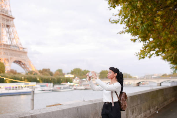 istock Smiling business woman standing on bridge and using smartphone 914702752