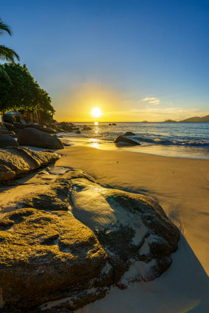 istock beautiful romantic sunset, seychelles beach, golden sand, blue water 2 914703074