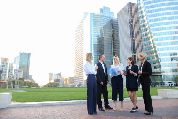 istock Biz partners advising and calling by smartphone outside 914703136
