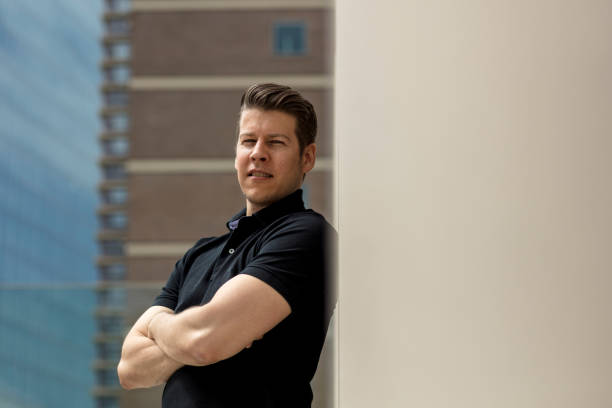 istock Portrait Of Young Man Standing Against Wall 914703660