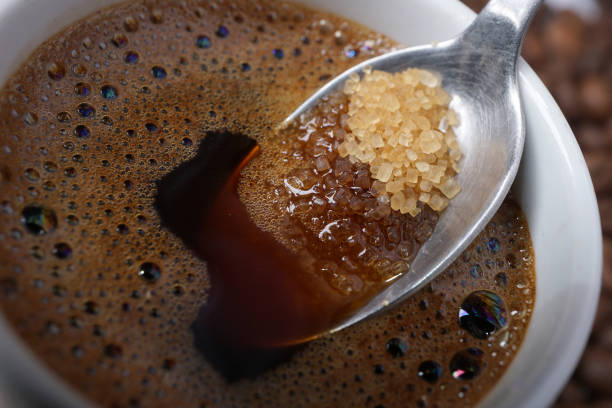 Close up of adding brown sugar in traditional Turkish coffee stock photo