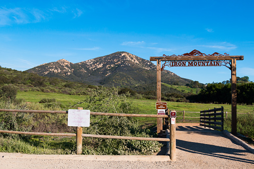Poway, California - March 16, 2017:  Wooden fence and trailhead sign to the Iron Mountain trail, a popular looped trail of 5.6 miles of moderate intensity in San Diego County.