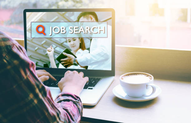 istock Rear view of people using a laptop computer for job searching and typing keyboard with looking for employment opportunities on the internet. 914729832
