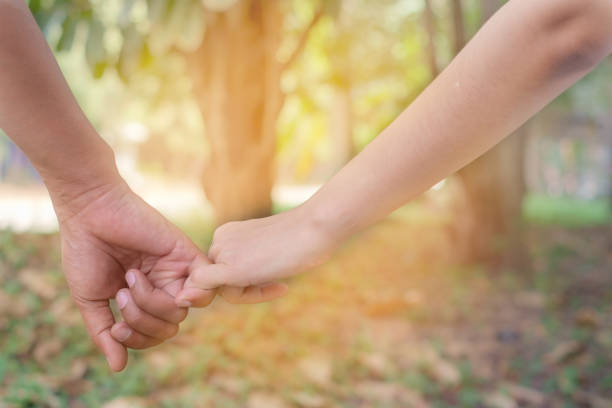 istock Loving couple holding hands on blurred background with sun light effect for Valentine's day and love concept 914739260