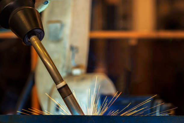 istock Close up team robots are welding in factory 914747752