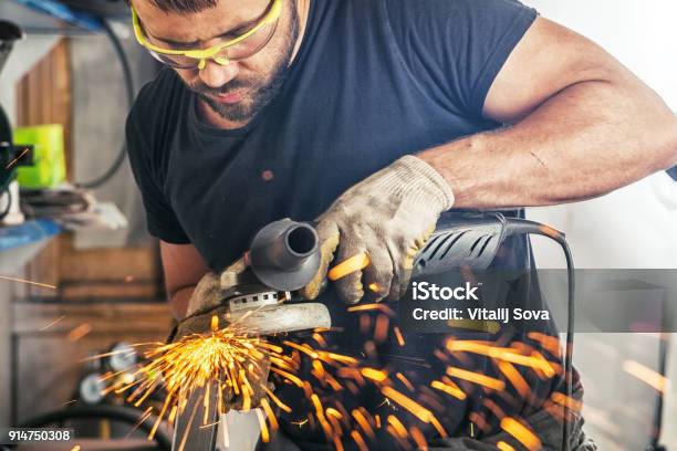 Man Processes Metal An Angle Grinder Stock Photo - Download Image Now - Adult, Adults Only, Angle