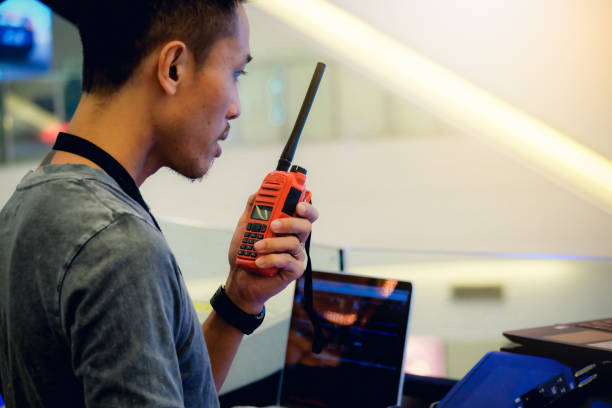istock Man with a Walkie Talkie or Portable radio transceiver for communication at event 914751092