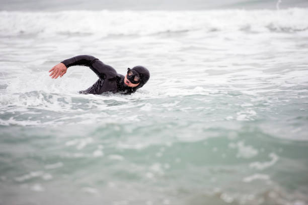 istock Professional free-diver man swimming in the open sea. 914754072