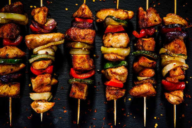 istock Kebabs - grilled meat and vegetables on wooden background 914754450