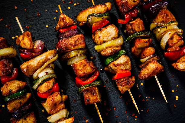istock Kebabs - grilled meat and vegetables on wooden background 914754634