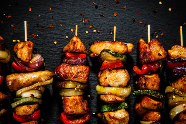istock Kebabs - grilled meat and vegetables on wooden background 914754678