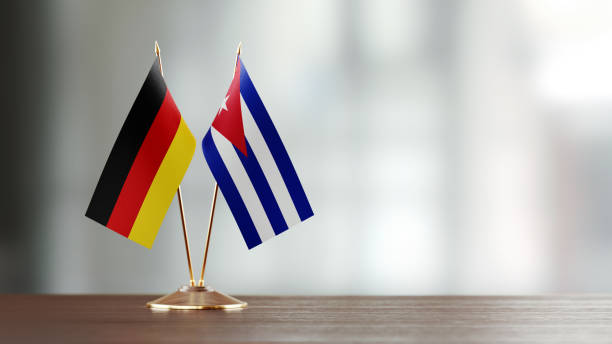 istock German And Cuban Flag Pair On A Desk Over Defocused Background 914754960