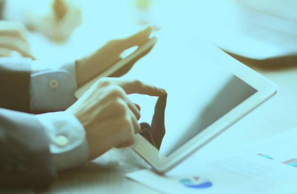 istock work of two young businessmen using touchpad in the meeting 914763550