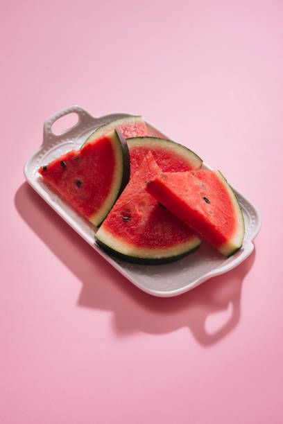 istock Fresh sliced watermelon in white dish on pink background. 914763646