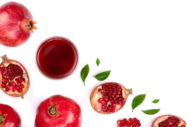 istock pomegranate juice with fresh pomegranate fruits isolated on white background with copy space for your text. Top view 914764686