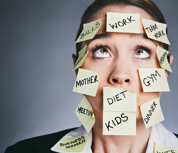 istock Beautiful businesswoman overburdened with responsibilities rolls her eyes 914768144