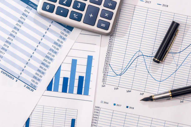 istock Financial development - calculator and pen on chart and graph paper. 914771754