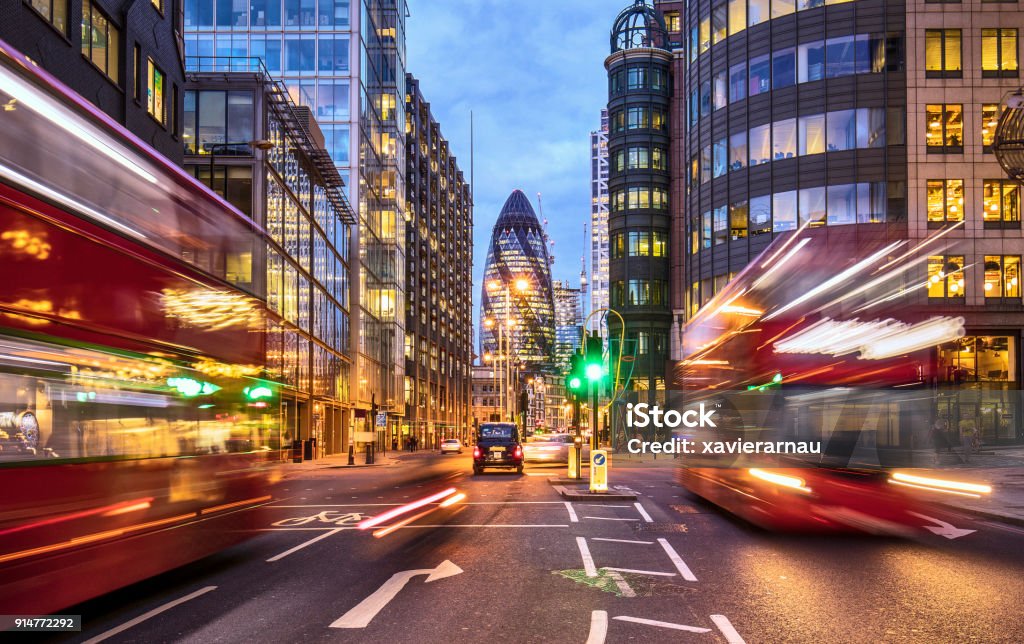 Financial district in London at dusk Financial district in London at dusk with buses driving through. London - England Stock Photo