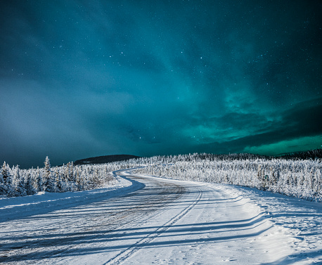 Northern lights over snow-covered road,Yukon,Canada.