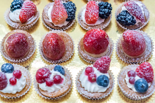 istock Different sort of small sweet cakes with vanilla, chocolate, berries and sugar powder. Selective focus 914775016