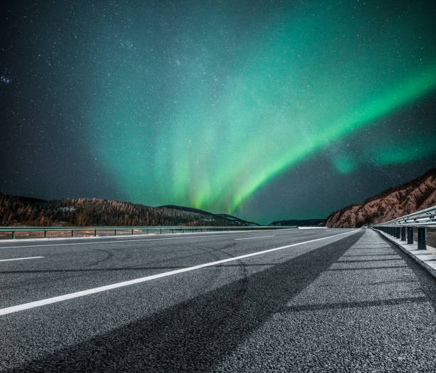 istock aurora borealis over asphalt road in Canada 914775070