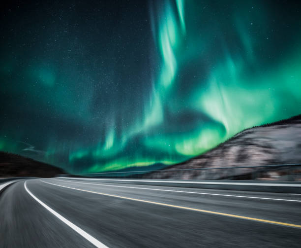 istock aurora borealis over blurred asphalt road in Canada 914776176