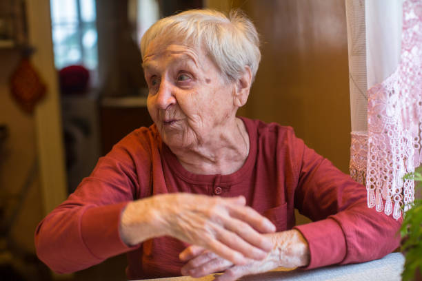 istock Emotional elderly woman sitting at the table. 914776358