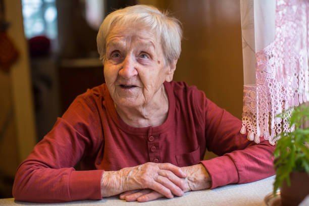 istock Emotional elderly woman sitting at the table. 914776366