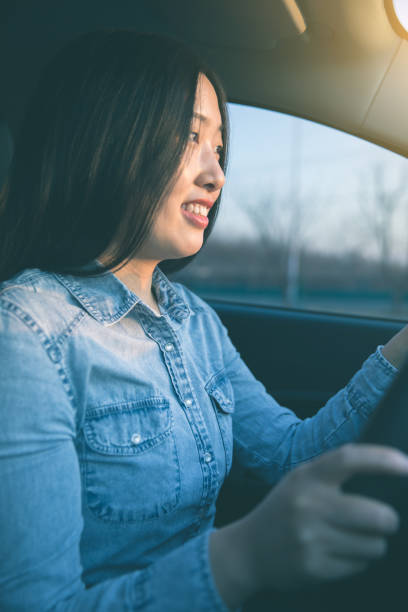 istock Young asian woman driving a car 914776430