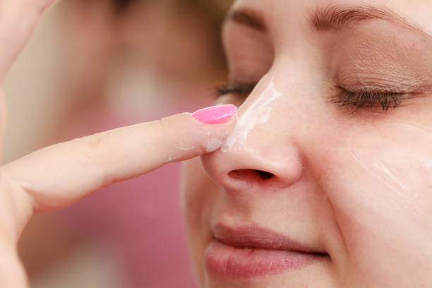 istock Woman applying face cream with her finger 914776814