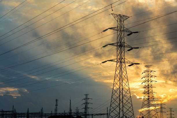 istock Majestic sunset with cloudscape behind high voltage electrical towers 914776884