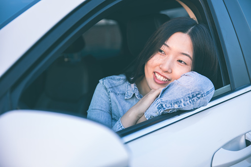 Young woman enjoying in a car